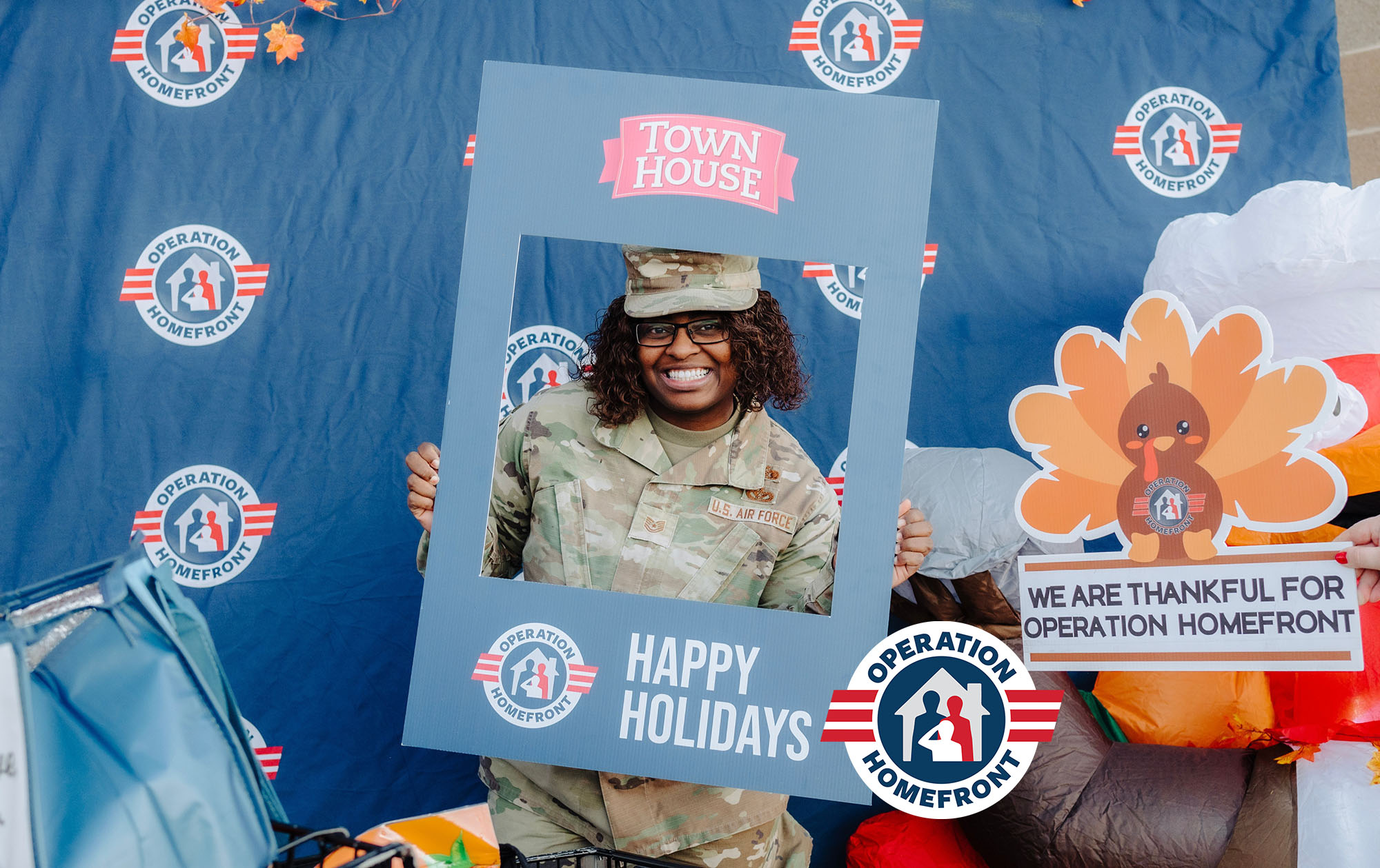 Operation Homefront  - a soldier holding a Happy Holidays frame.